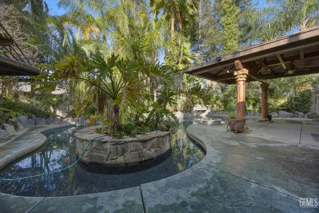 a view of backyard with outdoor seating and green space