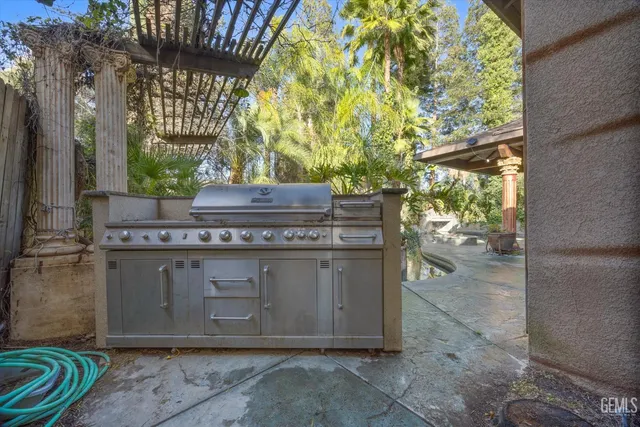 a swimming pool with outdoor seating yard and barbeque oven