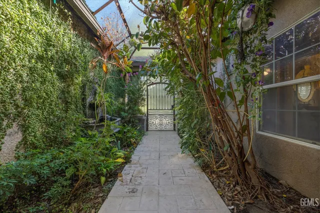 a view of a pathway both side of house