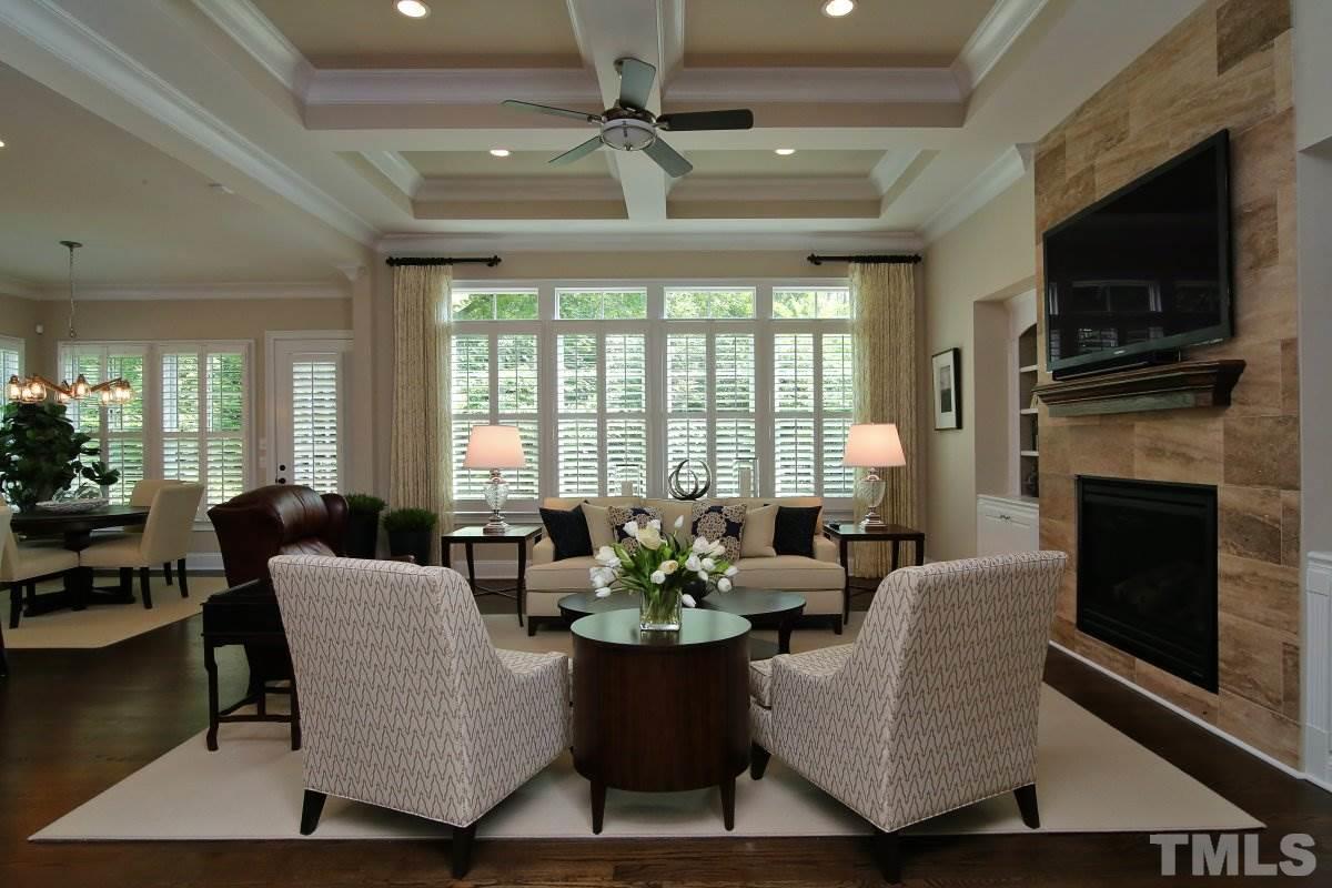 4106 English Garden Way Raleigh, NC 27612 - Photo 11 of 25 Trey ceilings, stone detailed fireplace and hardwood floors in this open family room.