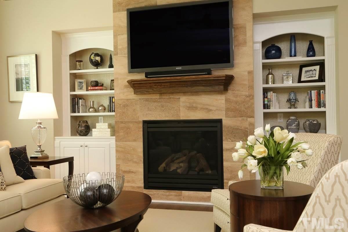 4106 English Garden Way Raleigh, NC 27612 - Photo 12 of 25 Stone detailed fireplace with built-in shelves.