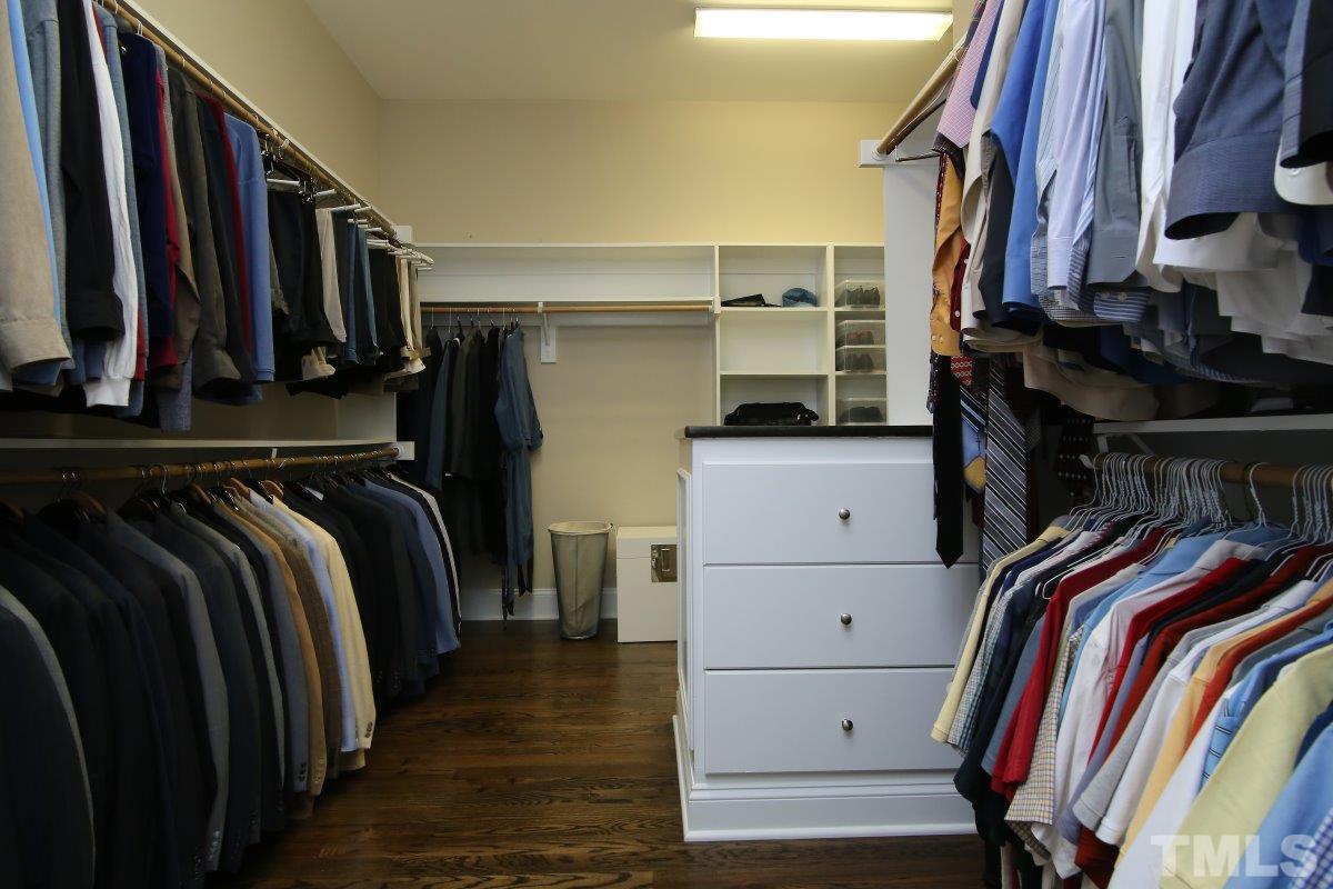4106 English Garden Way Raleigh, NC 27612 - Photo 15 of 25 Custom built in shelves with island in this spacious master closet.