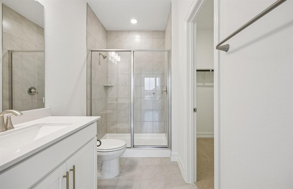 11216 Abbotsbury Road Fort Worth, TX 76052 - Photo 20 of 20 a bathroom with a shower sink vanity mirror and toilet