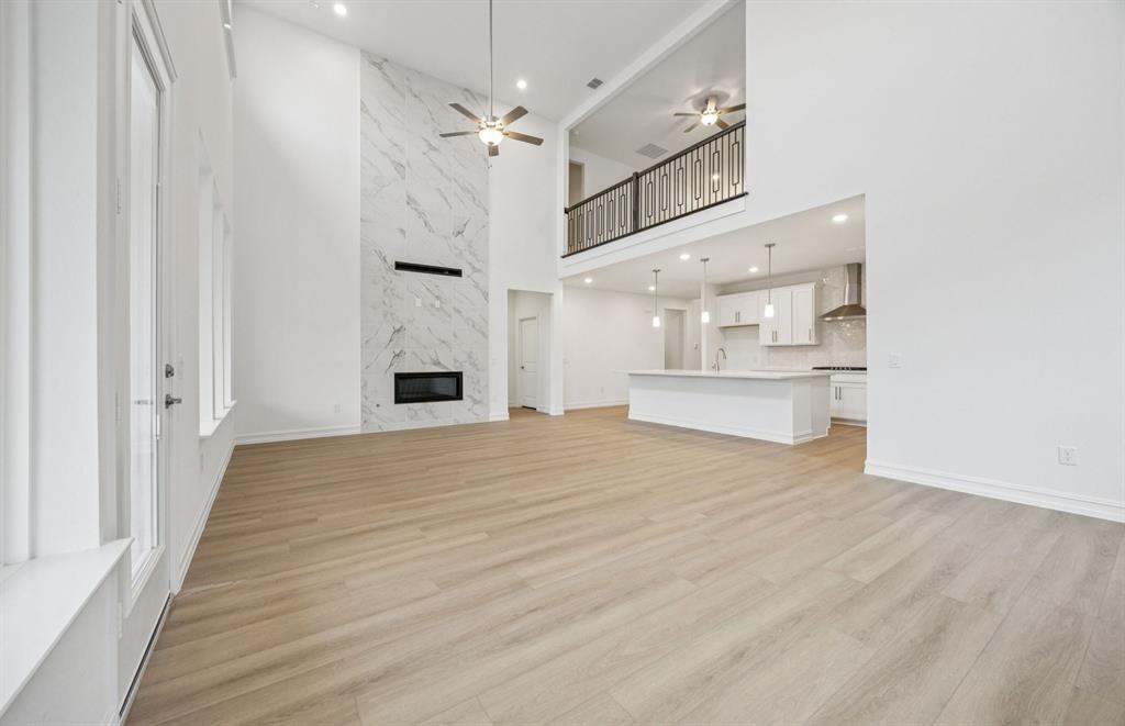 11216 Abbotsbury Road Fort Worth, TX 76052 - Photo 6 of 20 a view of an empty room with a fireplace and cabinet