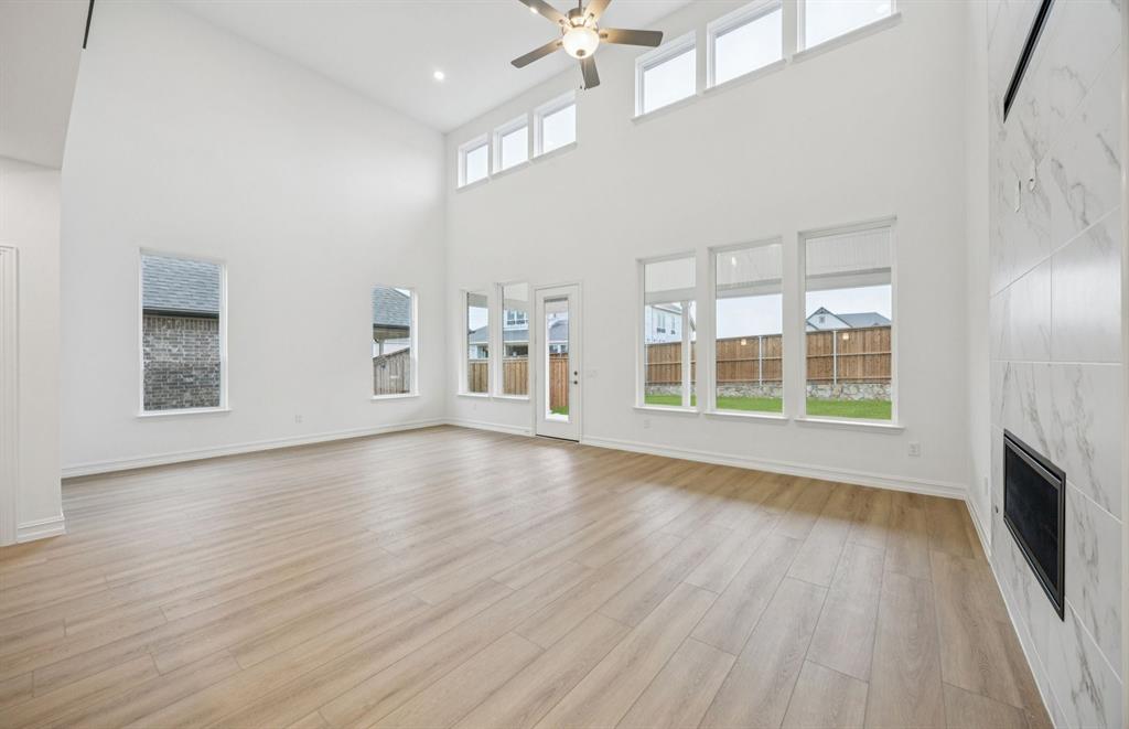 11216 Abbotsbury Road Fort Worth, TX 76052 - Photo 7 of 20 an empty room with wooden floor and windows
