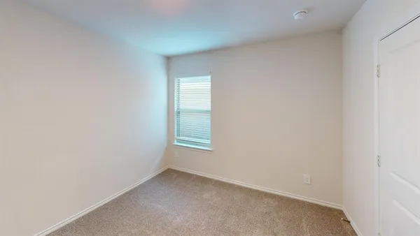 a view of an empty room and a window