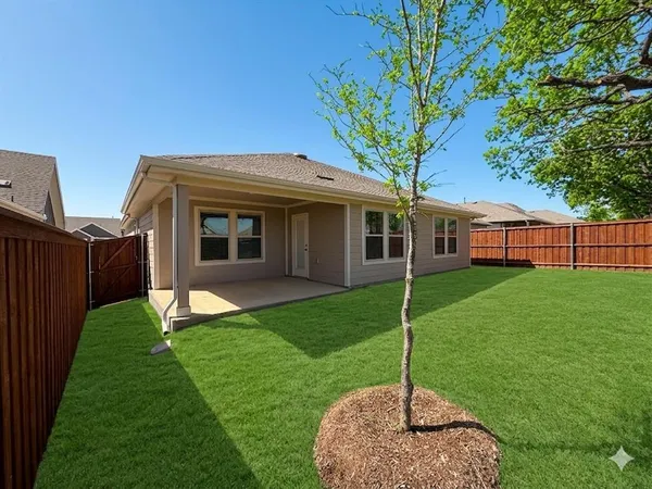 a house view with a sitting space and garden