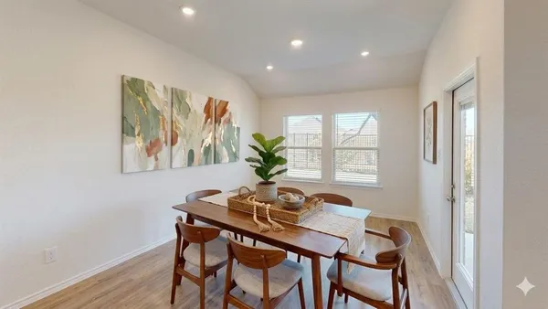 a dining room with furniture and wooden floor