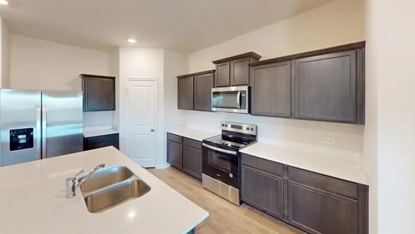 a kitchen with a sink cabinets and stainless steel appliances