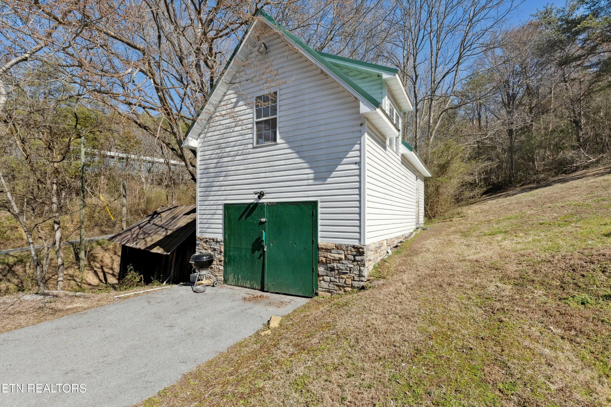 1216 Powder Springs Road Sevierville, TN 37876 - Photo 32 of 45 a view of a house with a yard and garage