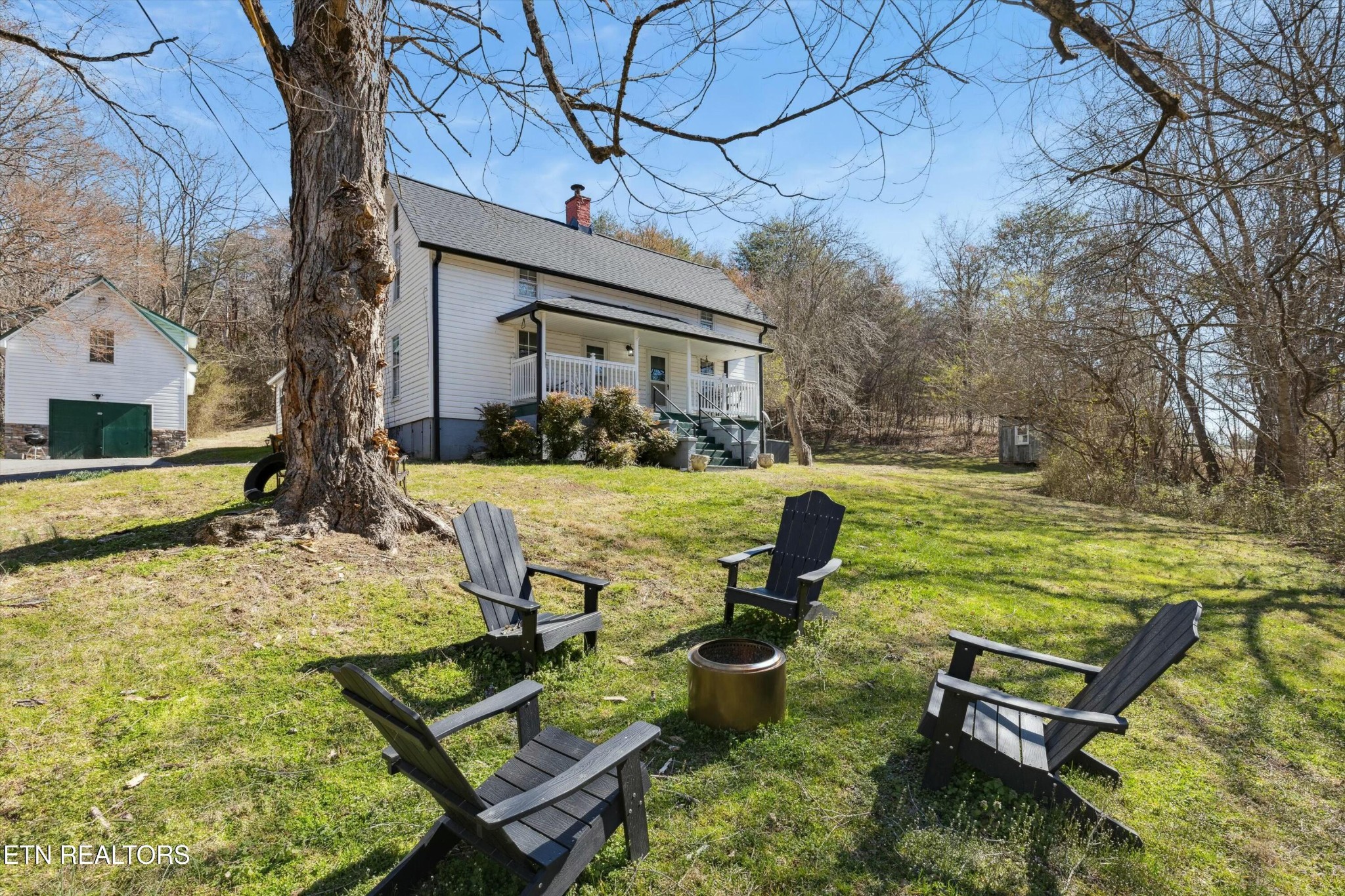 1216 Powder Springs Road Sevierville, TN 37876 - Photo 33 of 45 a view of a backyard with chairs potted plants and a large tree