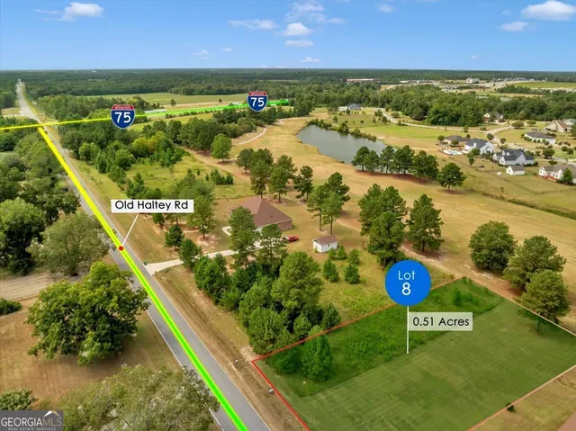 an aerial view of a golf course with a lake view