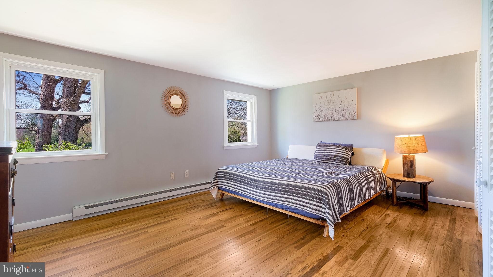 152 Blooming Glen Road Perkasie, PA 18944 - Photo 18 of 37 a bedroom with a bed and a painting on the wall
