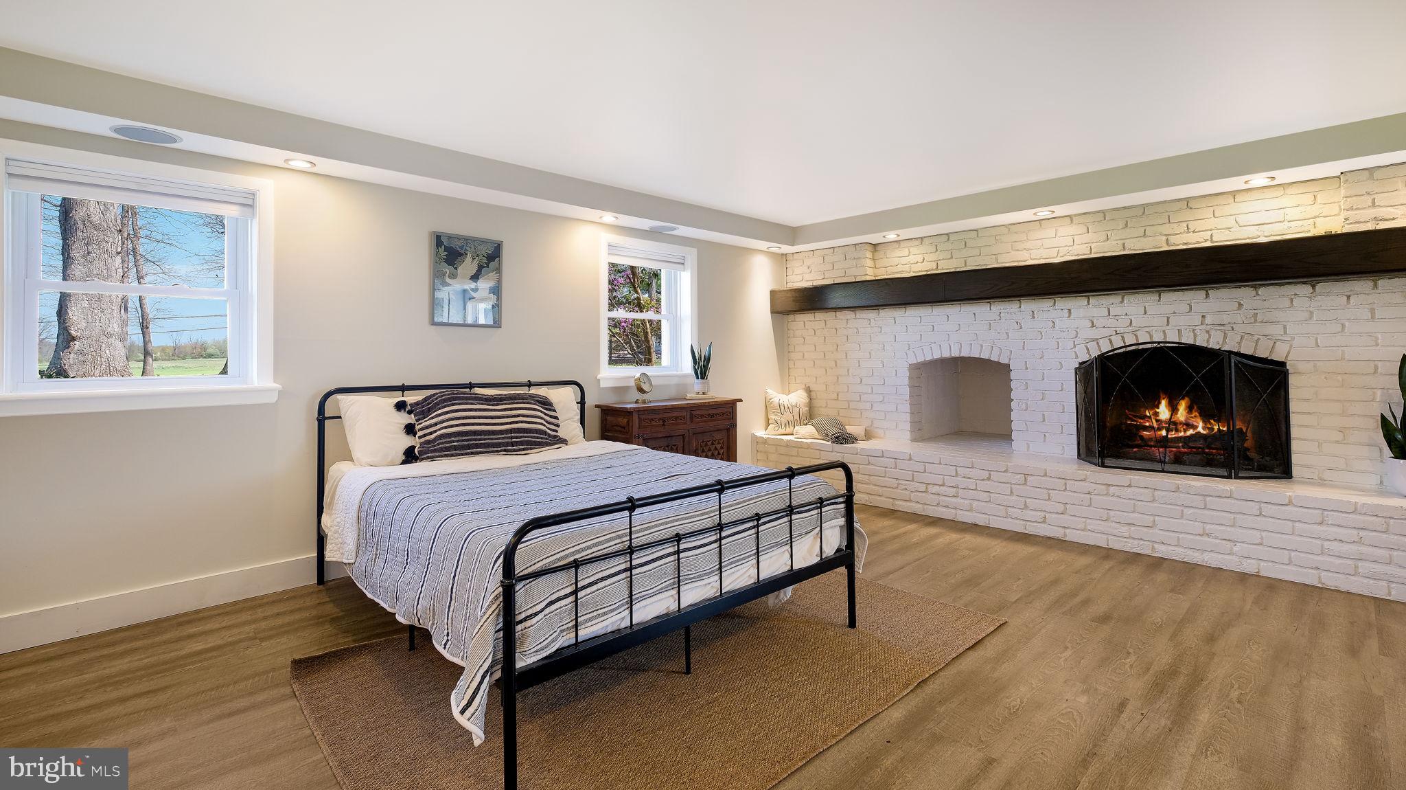 152 Blooming Glen Road Perkasie, PA 18944 - Photo 24 of 37 a spacious bedroom with a bed and a fireplace