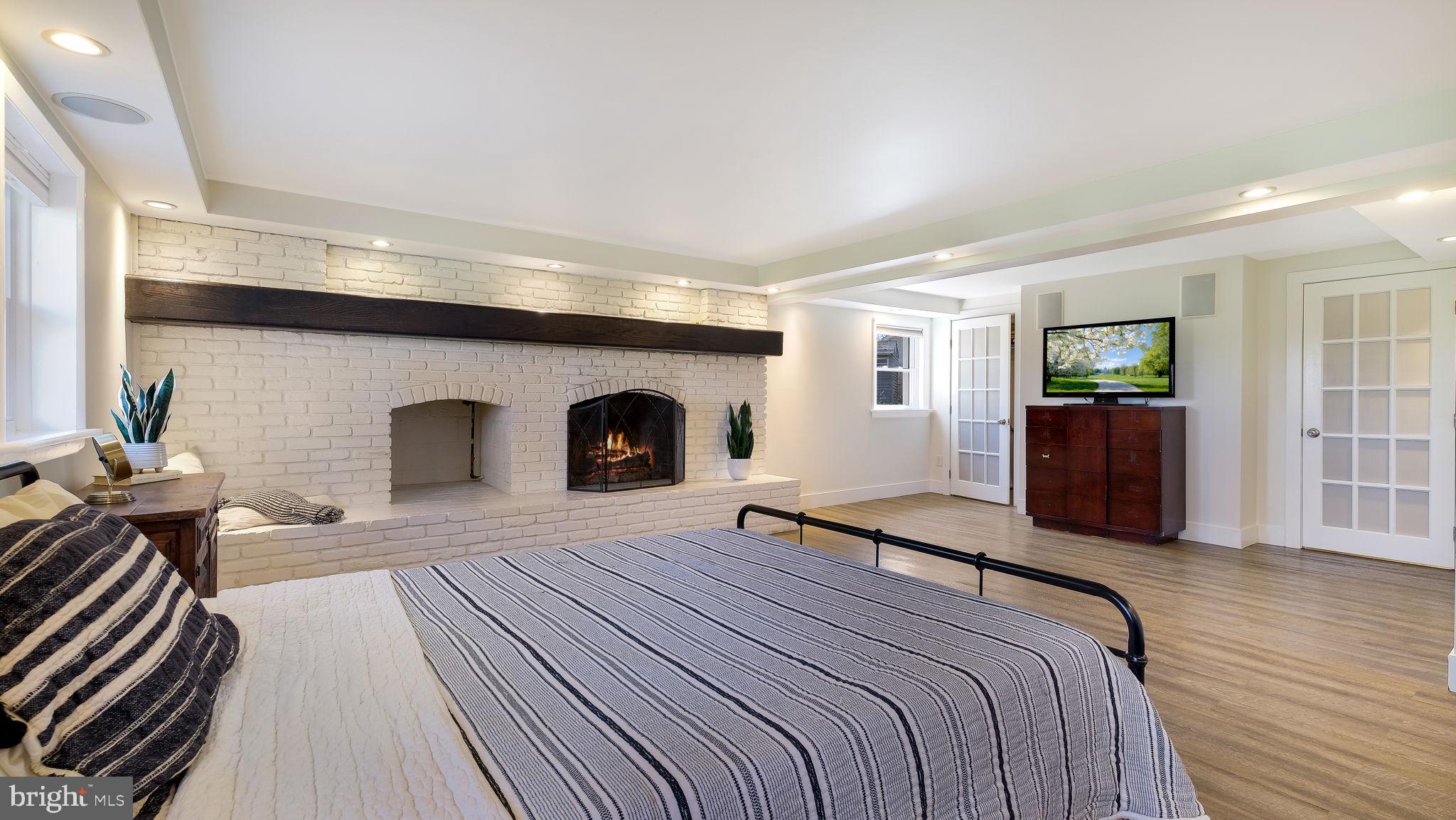 152 Blooming Glen Road Perkasie, PA 18944 - Photo 26 of 37 a bedroom with a large bed and a fireplace