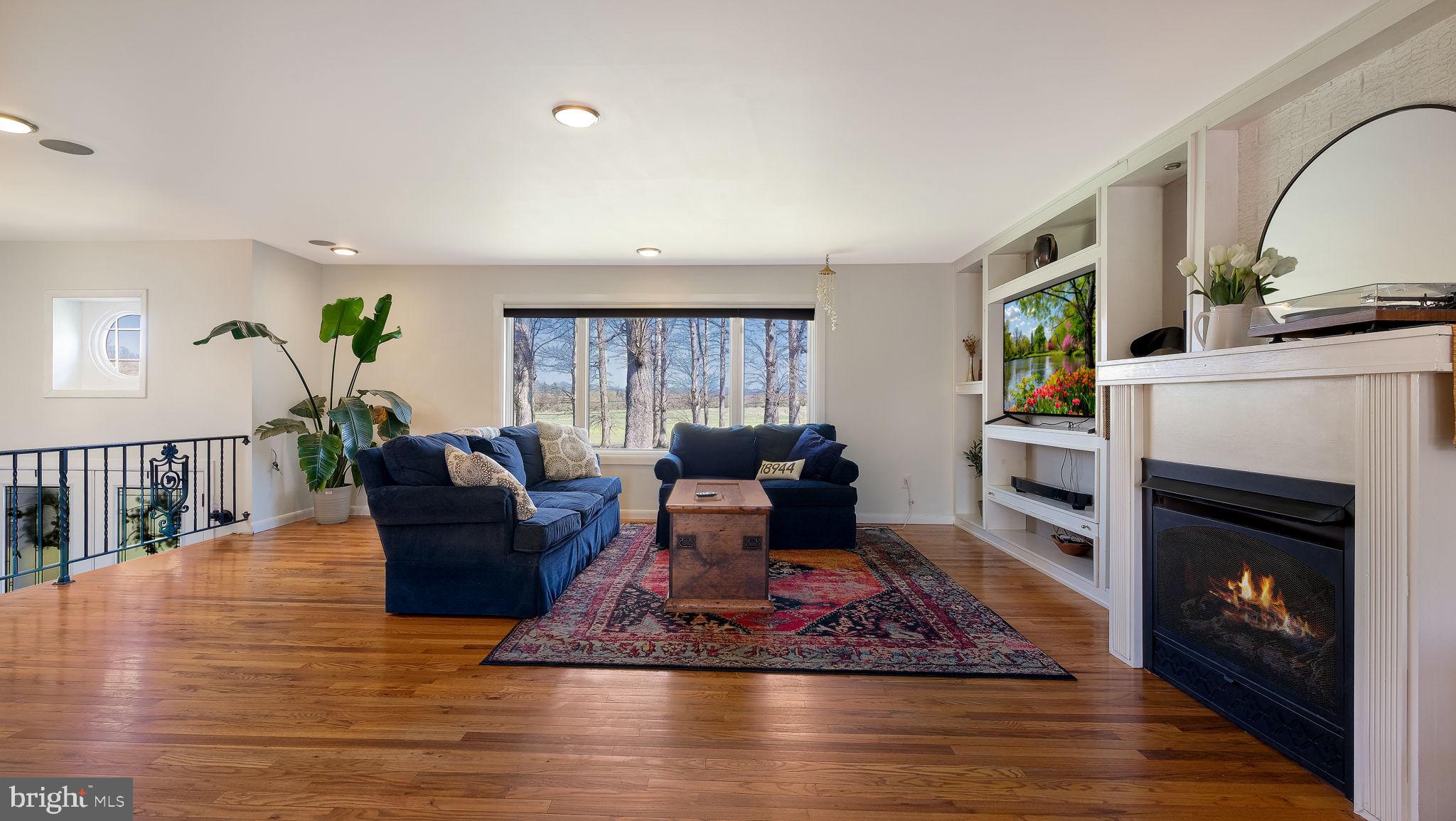 152 Blooming Glen Road Perkasie, PA 18944 - Photo 9 of 37 a living room with furniture a fireplace and a rug