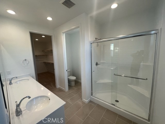 31373 Trappers Loop Winchester, CA 92596 - Photo 14 of 15 a bathroom with a granite countertop sink a toilet and shower