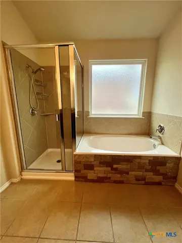 a bathroom with a tub and a shower