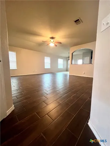 a view of a room with an empty space and a window