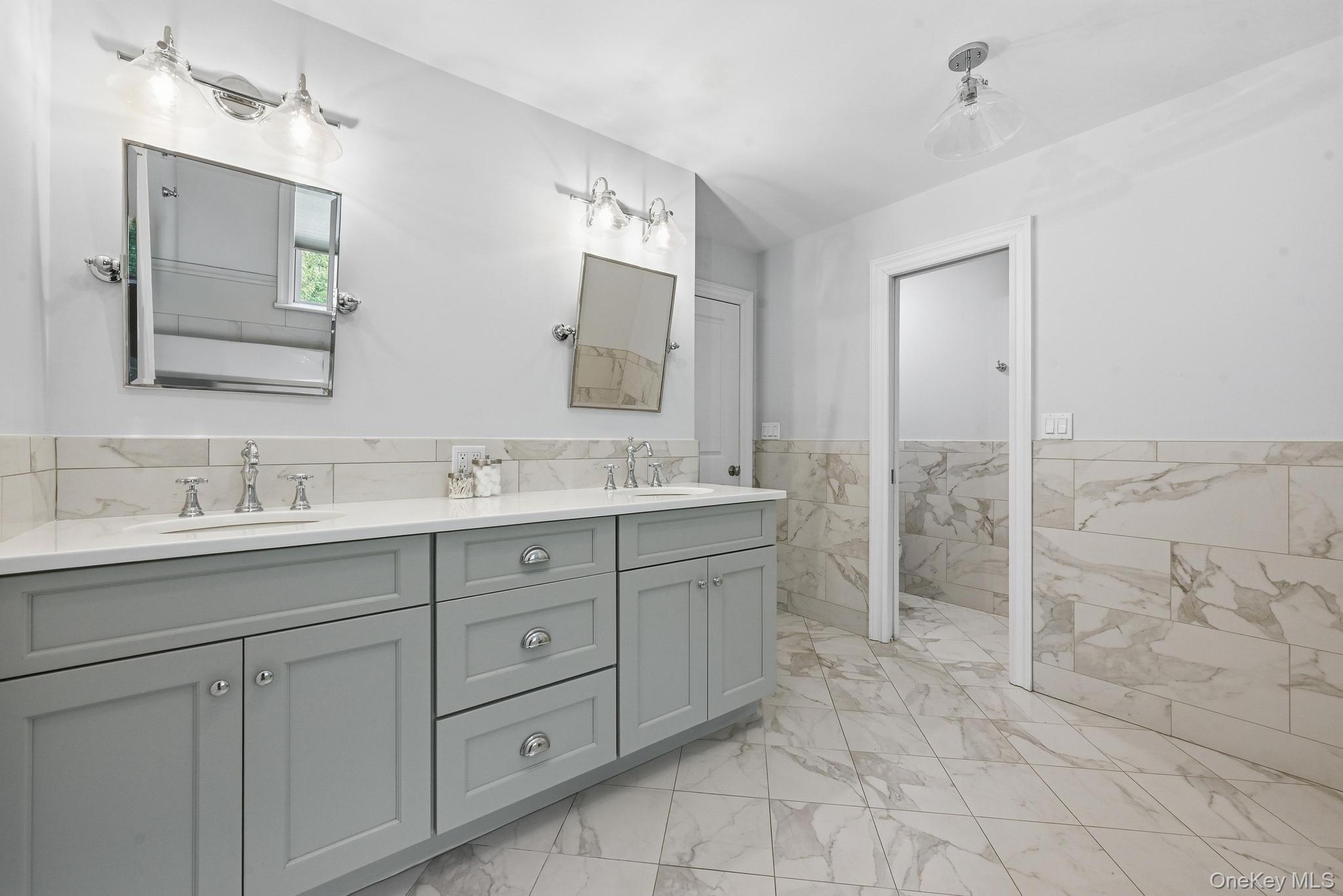 42 Skunks Misery Road Locust Valley, NY 11560 - Photo 35 of 50 Double vanity with light gray cabinetry, quartz countertop, and chrome fixtures