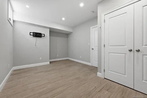 an empty room with wooden floor and closet