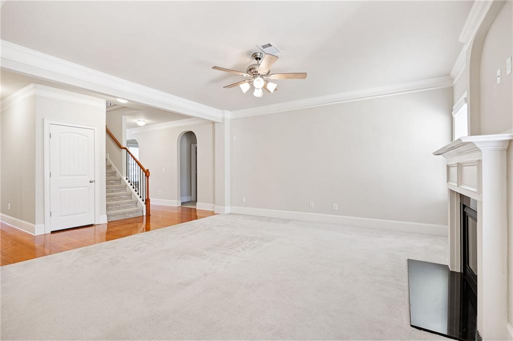 66 Lanier Ridge Acworth, GA 30101 - Photo 16 of 53 a view of an empty room with chandelier fan and wooden floor