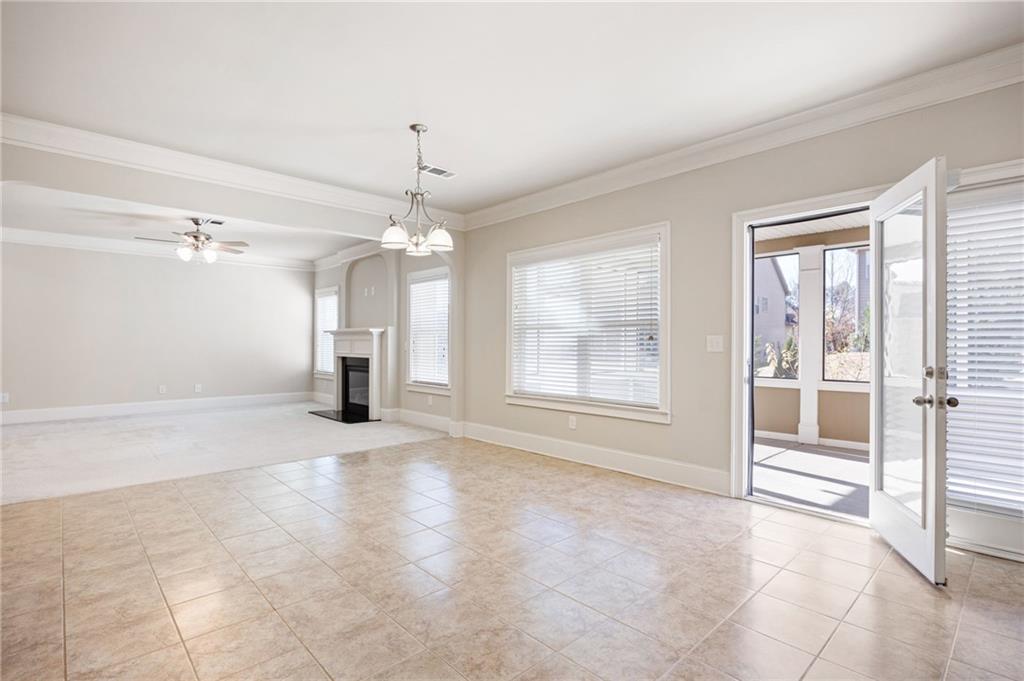 66 Lanier Ridge Acworth, GA 30101 - Photo 19 of 53 an empty room with chandelier fan and windows