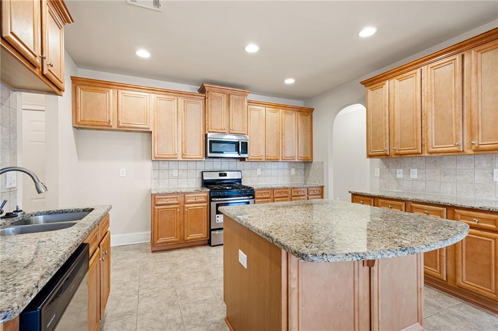 66 Lanier Ridge Acworth, GA 30101 - Photo 23 of 53 a kitchen with stainless steel appliances granite countertop a sink stove and cabinets