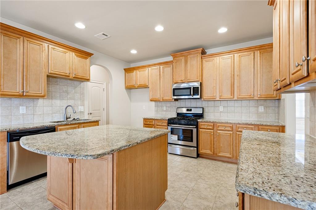 66 Lanier Ridge Acworth, GA 30101 - Photo 24 of 53 a kitchen with stainless steel appliances granite countertop a stove a sink a microwave and a refrigerator