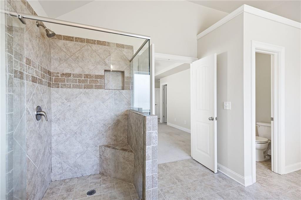 66 Lanier Ridge Acworth, GA 30101 - Photo 38 of 53 a bathroom with a shower and a glass door