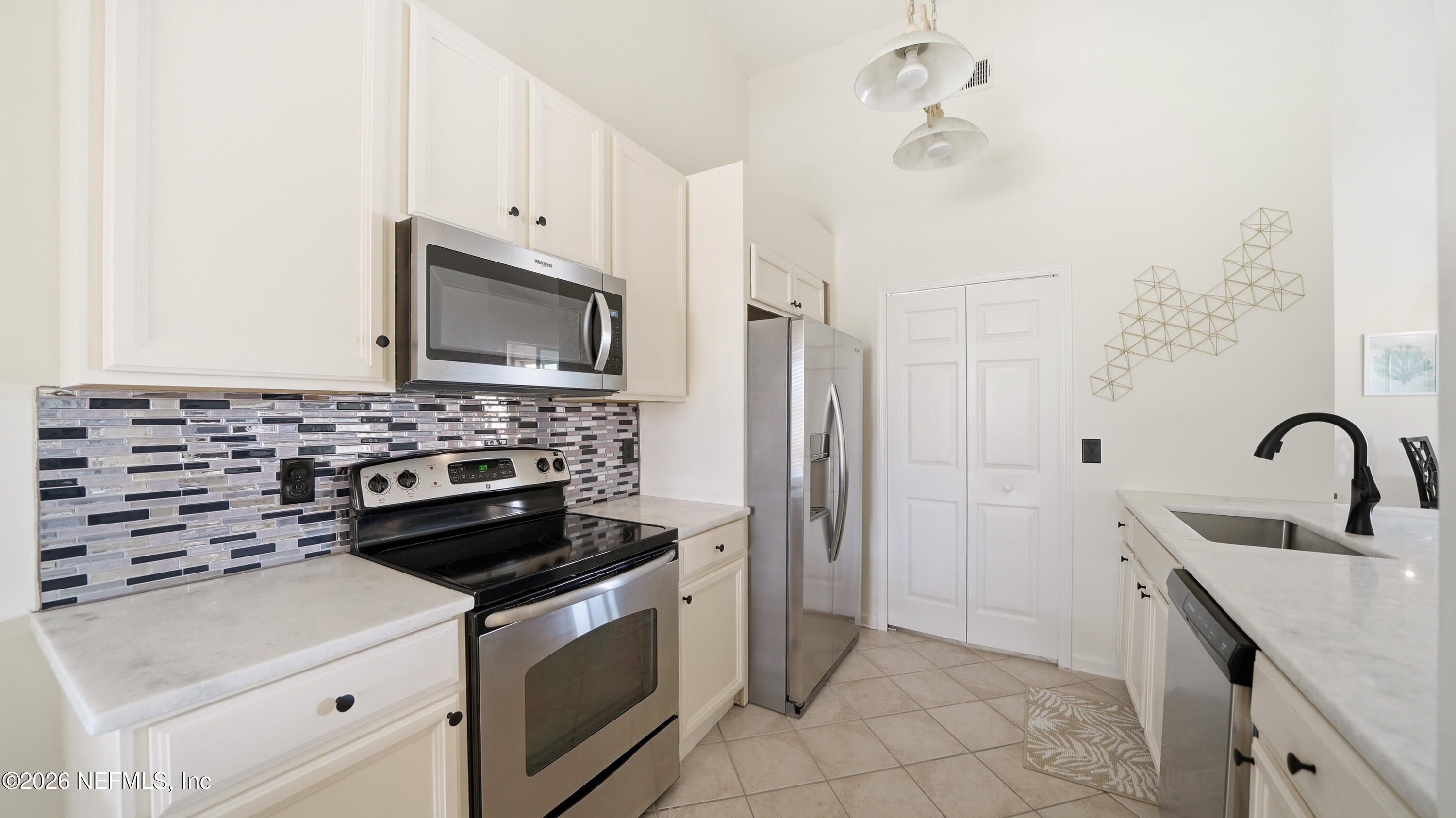 705 Augusta Circle St. Augustine, FL 32086 - Photo 12 of 53 a kitchen with a stove and a microwave