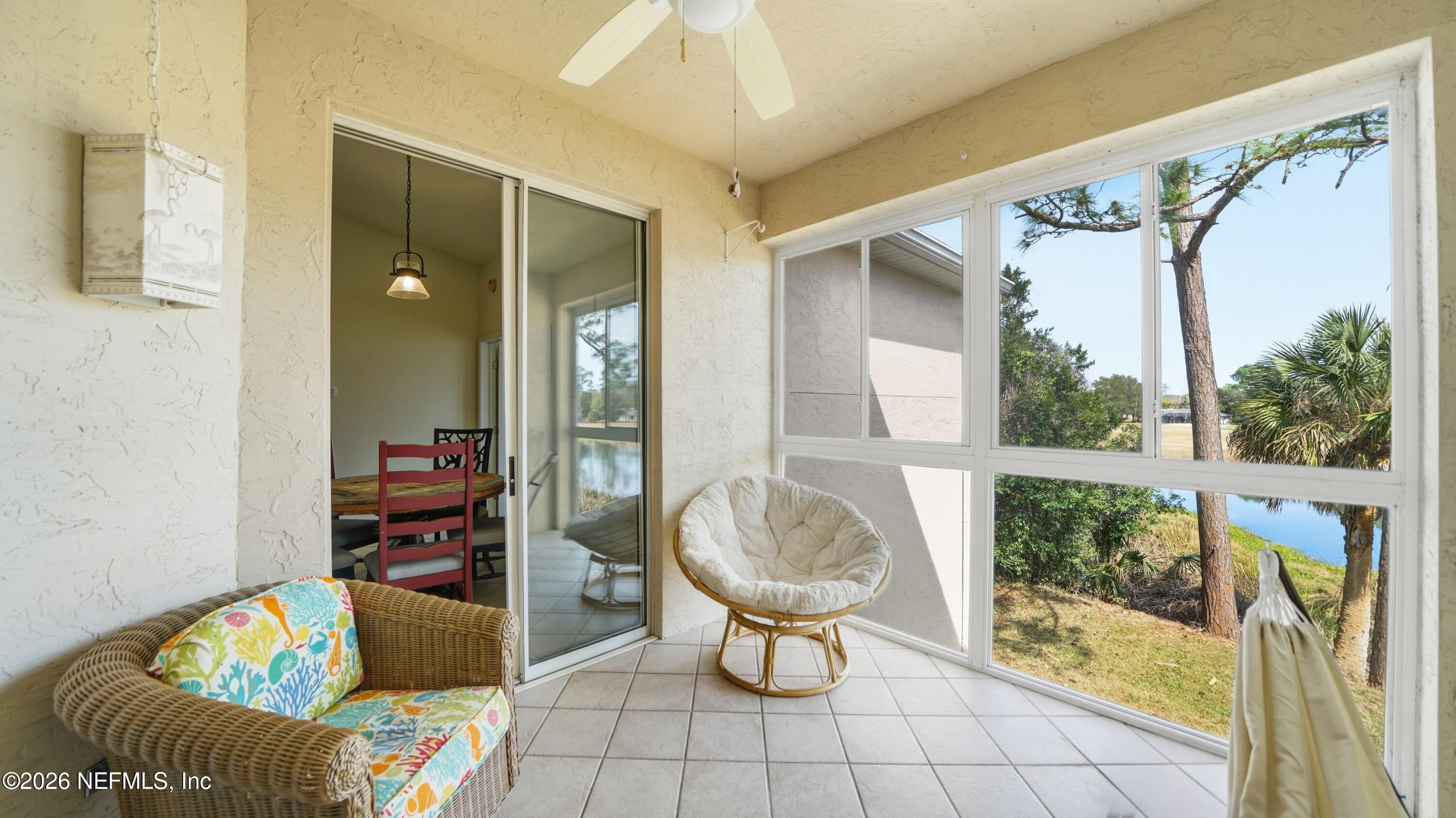 705 Augusta Circle St. Augustine, FL 32086 - Photo 17 of 53 a living room with furniture and a floor to ceiling window