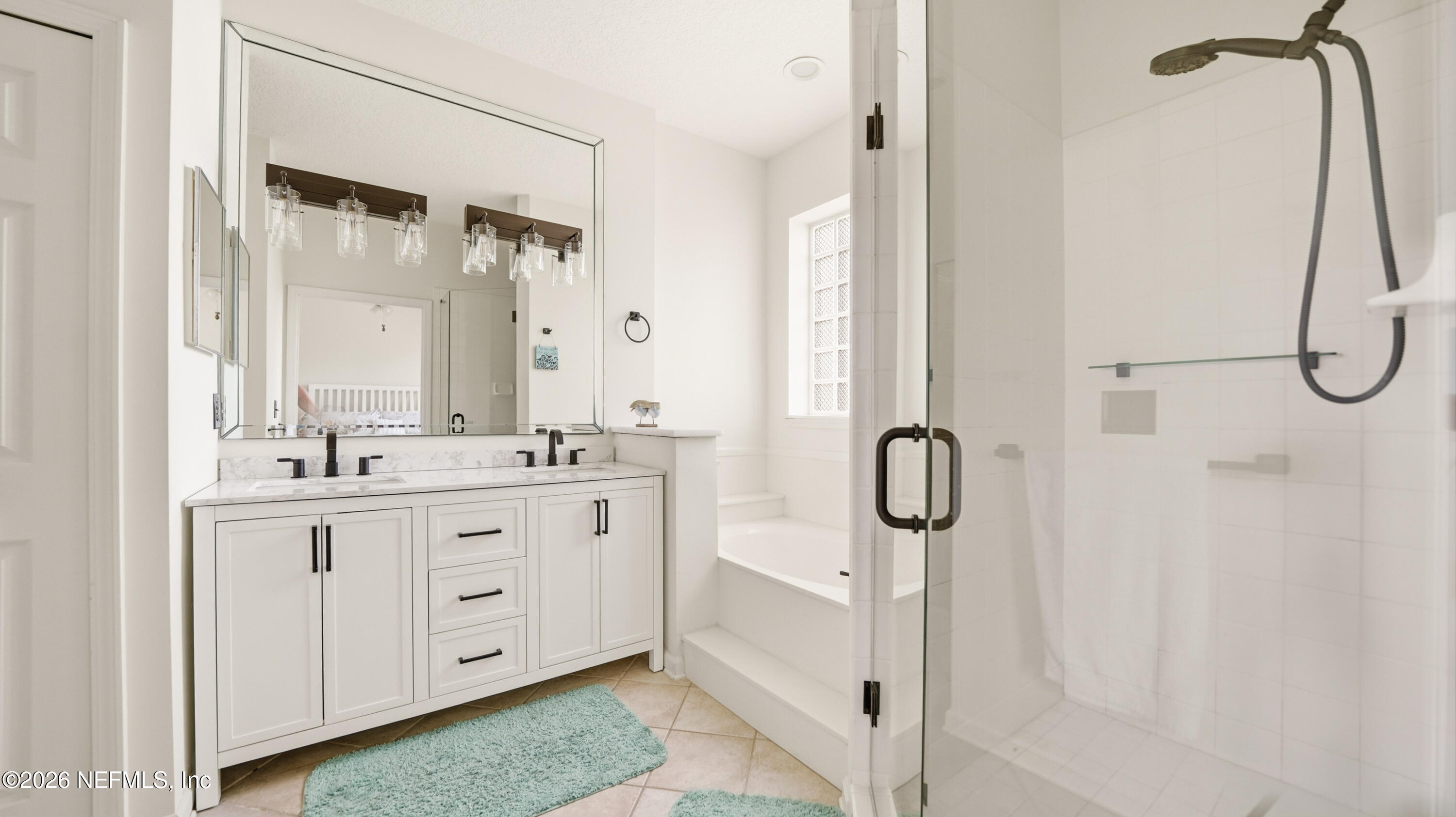 705 Augusta Circle St. Augustine, FL 32086 - Photo 21 of 53 a bathroom with a granite countertop sink mirror and a shower