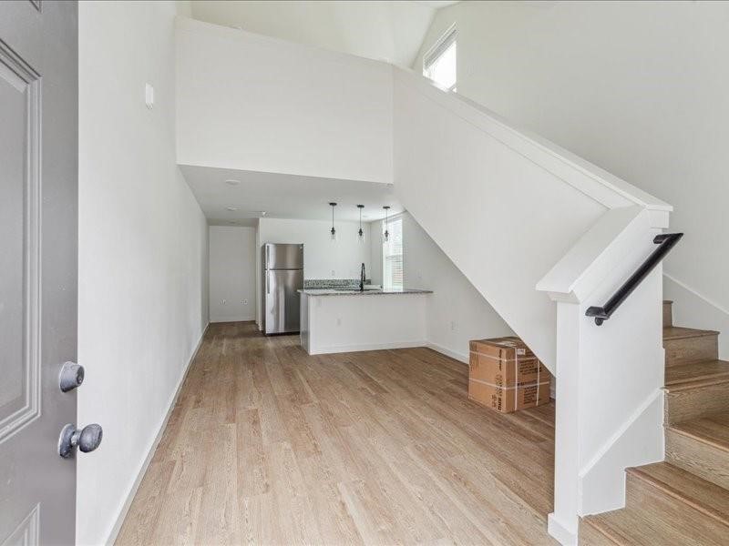 905 74th Street, Unit 3 Houston, TX 77011 - Photo 2 of 10 a view of a hallway with wooden floor and staircase