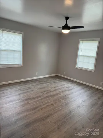 an empty room with wooden floor and closet