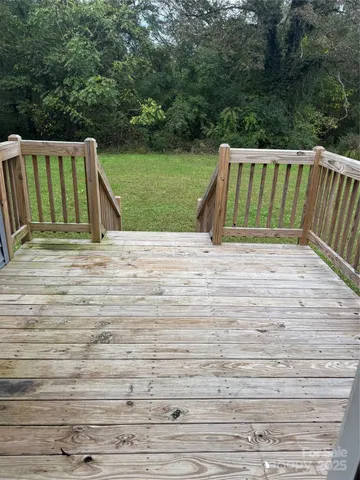 a view of backyard with deck and barbeque oven