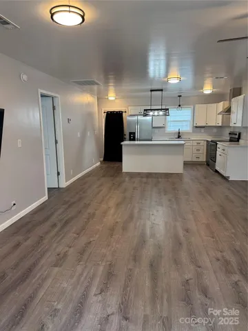 a living room with furniture and kitchen view