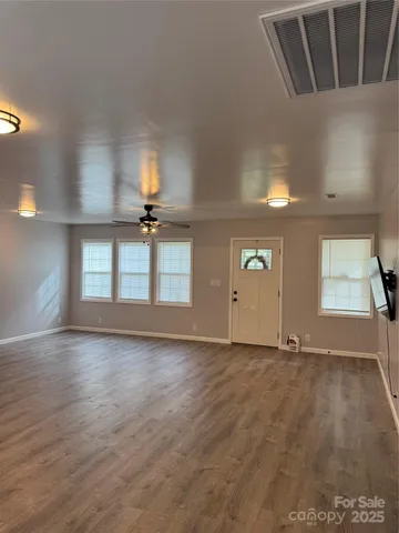 a view of a kitchen with a sink cabinets and wooden floor