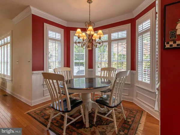 a view of a dining room with furniture large windows and wooden floor