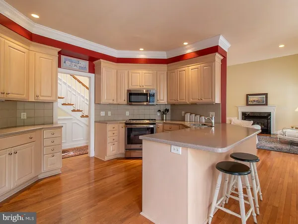 a large kitchen with stainless steel appliances granite countertop a stove a sink and a refrigerator