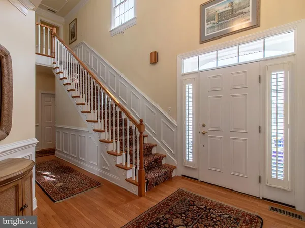 a view of entryway with wooden floor and stairs