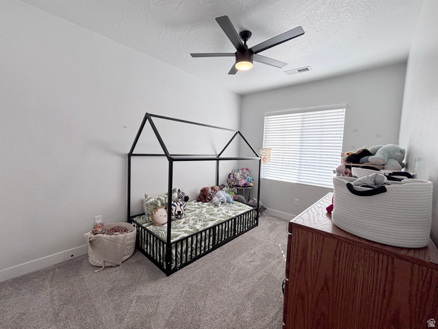 429 East Treasure Road Washington, UT 84780 - Photo 18 of 36 Bedroom featuring ceiling fan, carpet flooring, and a textured ceiling