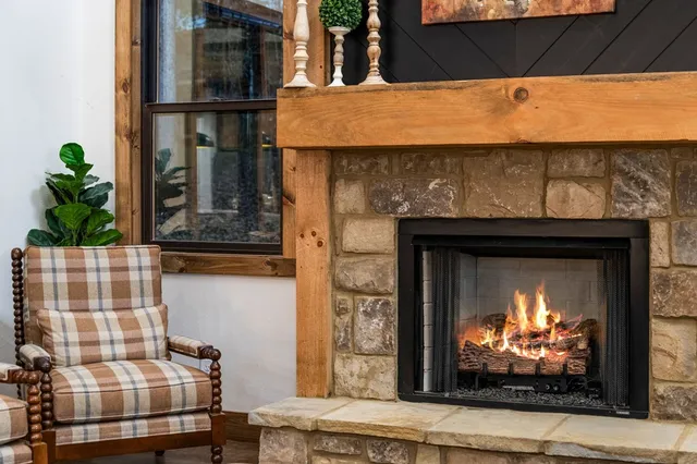 a kitchen with stainless steel appliances granite countertop a sink a stove and a wooden cabinets