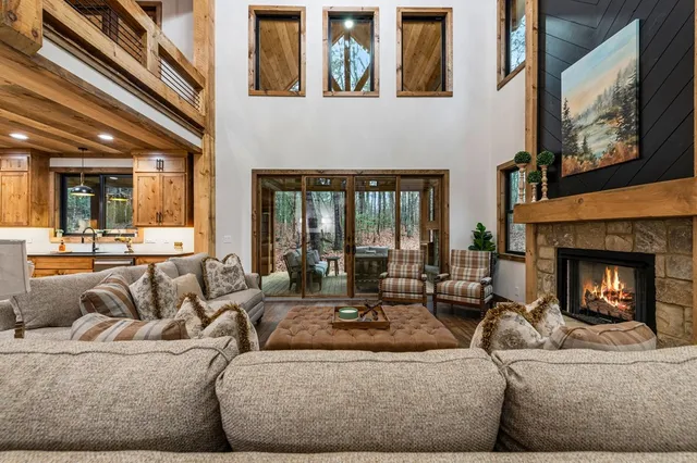 a living room with furniture a fireplace and a table