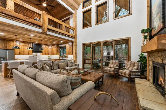 a living room with furniture and a floor to ceiling window
