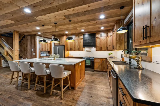 a view of a patio with couches chairs and wooden floor