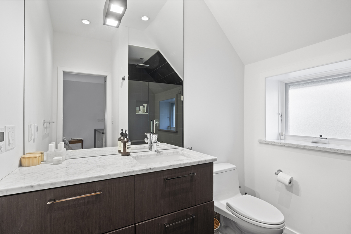 1226 North Dearborn Street, Unit B Chicago, IL 60610 - Photo 16 of 22 a bathroom with a granite countertop sink a toilet and mirror