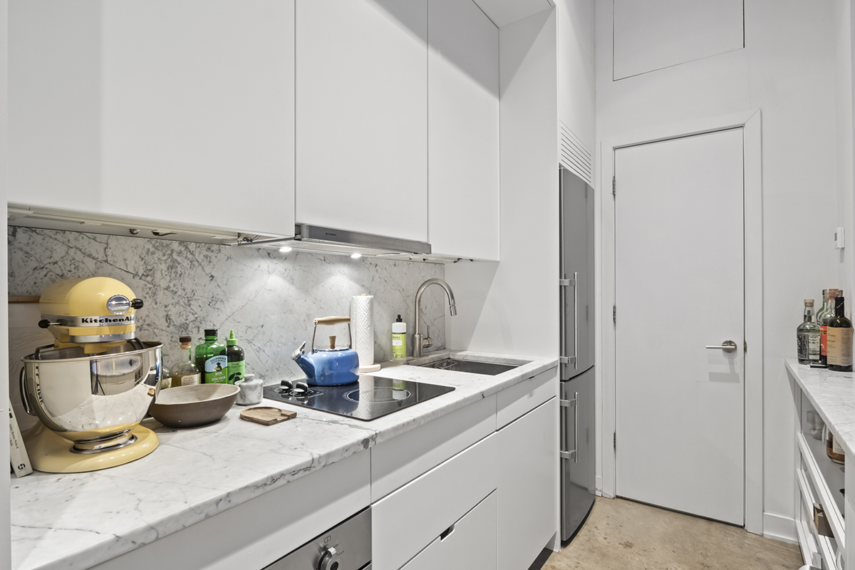 1226 North Dearborn Street, Unit B Chicago, IL 60610 - Photo 7 of 22 a kitchen with a sink and cabinets