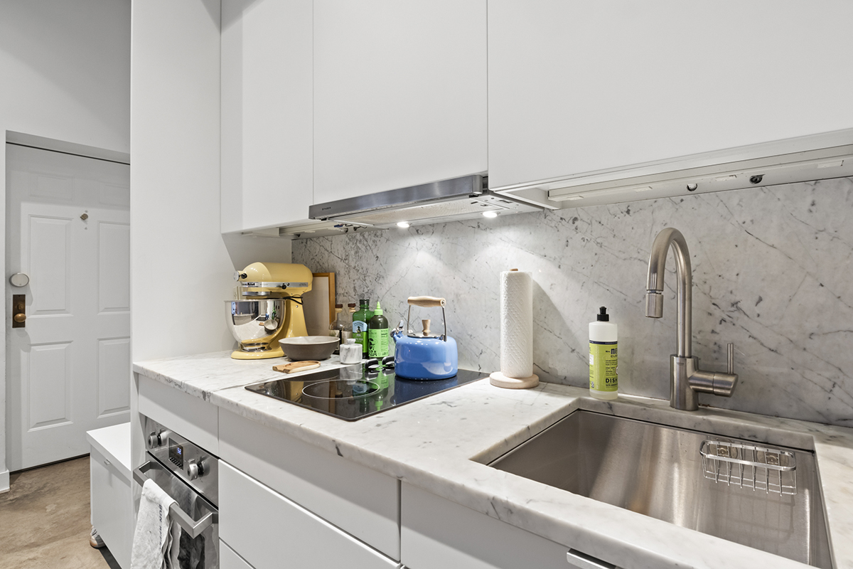 1226 North Dearborn Street, Unit B Chicago, IL 60610 - Photo 8 of 22 a kitchen with a sink and a refrigerator