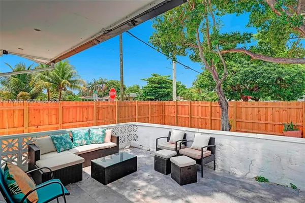 a patio with patio a couch and chairs